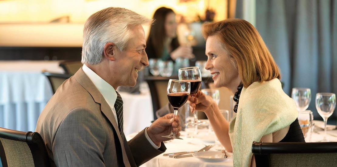 A couple drinking wine at dinner, in the ship's restaurant